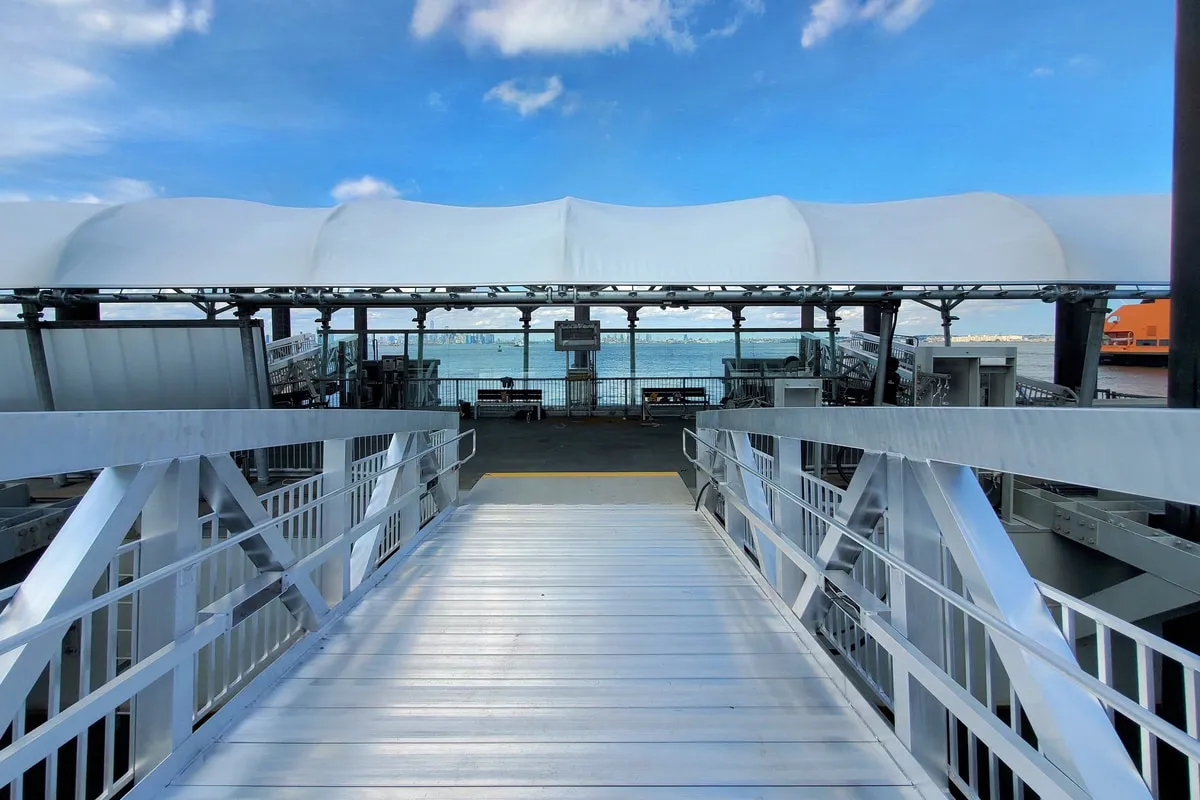 Passenger gangway and canopy at the St. George ferry landing, Staten Island Ferry at berth.