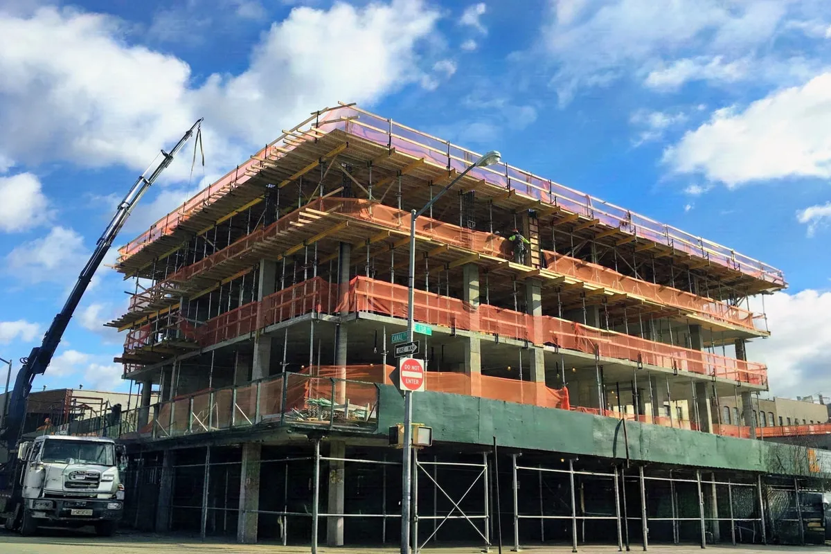 The Joinery under construction at 225 East 138th Street, Mott Haven, concrete frame and shoring in place.